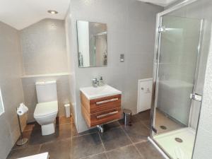 a bathroom with a toilet and a sink and a shower at Kelsick Heights in Ambleside +15 photos
