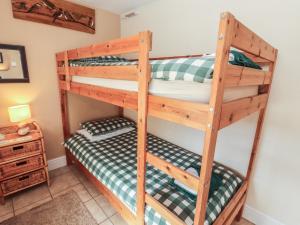a couple of bunk beds in a room at Piggery Cottage in Wigton