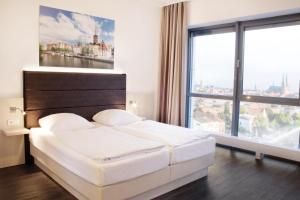 Postel nebo postele na pokoji v ubytování Viva Hotel Lübeck