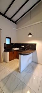a large kitchen with a island in a room at Coco Villa in Talpe +36 photos