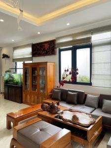 a living room with a couch and a table at An Phát Villa Đà Lạt in Da Lat