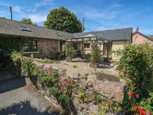 an exterior view of a cottage with a garden at Stoney Cottage in Narberth
