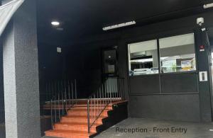 a building with stairs in front of a building at Karinga Motel Lismore in Lismore