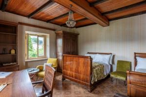 a bedroom with a bed and a table and chairs at Lake Orta Villa Retreat in Pella