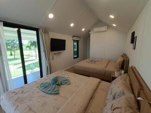 a room with two beds and a table with a hat on it at Honeymoon in Pong Talong