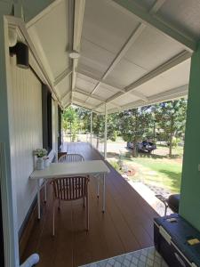 a porch with a table and chairs on a deck at Honeymoon in Pong Talong