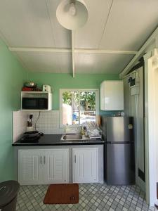 a kitchen with a refrigerator and a sink at Honeymoon in Pong Talong +9 photos