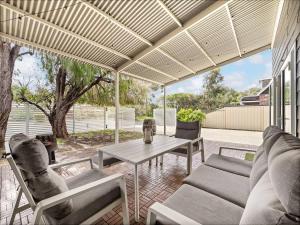 an outdoor living room with a table and chairs at Pepper Cottage - Easy Beachside Living Close to Town in Dunsborough