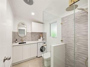 a white bathroom with a toilet and a sink at Pepper Cottage - Easy Beachside Living Close to Town in Dunsborough