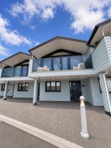 a large white house with a lot of windows at Seaside Escape in Westward Ho! 3-Bed Family Holiday Home with Sea Views in Westward Ho
