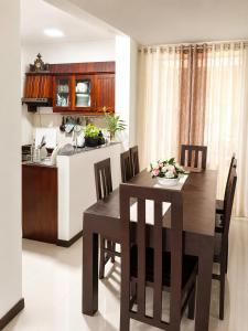 a kitchen and dining room with a table and chairs at Ayubowan Home Stay - Kotikawatta in Angoda