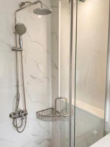 a bathroom with a shower with a glass door at An Phát Villa Đà Lạt in Da Lat +19 photos
