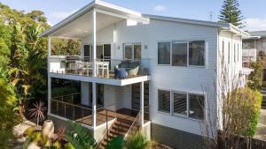 a white house with a deck and a balcony at Casa Bianca - Oceanview Beachside Escape in Dunsborough