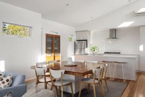a kitchen and dining room with a table and chairs at Casa Bianca - Oceanview Beachside Escape in Dunsborough