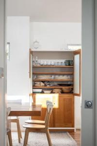 a dining room with a table and a table and chairs at Casa Bianca - Oceanview Beachside Escape in Dunsborough