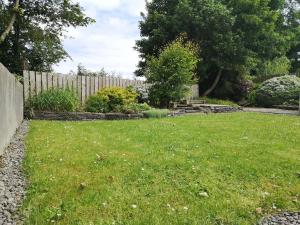 a yard with a fence and green grass at Letterkenny View in Letterkenny