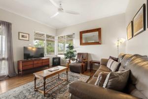 a living room with a couch and a tv at Hillview - Spacious Bushland Haven with Resort Access in Yallingup
