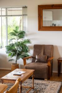 a living room with a couch and a table at Hillview - Spacious Bushland Haven with Resort Access in Yallingup +26 photos