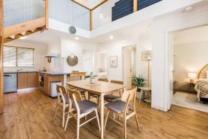 a kitchen and dining room with a table and chairs at Banksia at Whitesands - Villa 5 Loft-Style Living by the Bay in Dunsborough
