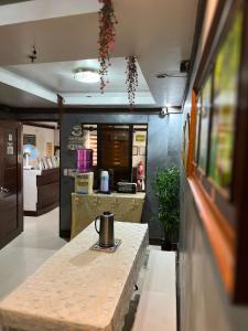 a kitchen with a table with a tea kettle on it at Jace's Travellers Inn El Nido near Corong Corong Beach in El Nido