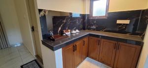 a kitchen with a sink and a counter top at Coco Villa in Talpe