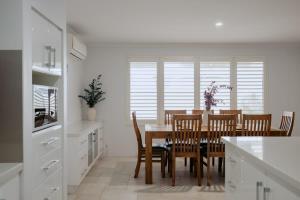 a kitchen with a dining room table and chairs at Luxury at the Cove - Seaside Comfort & Entertainment in Quindalup