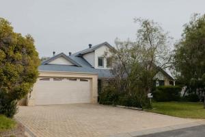 a large house with a white garage at Luxury at the Cove - Seaside Comfort & Entertainment in Quindalup