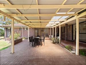 a covered patio with a table and chairs at Bluewater Retreat - Pet-Friendly Coastal Oasis in Broadwater +18 photos
