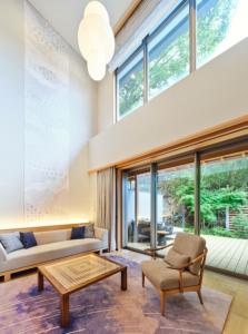 a living room with a couch and a table at ABBA Resorts Izu - Zagyosoh in Ito