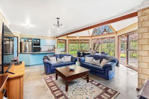 a living room with two couches and a table at Eagle Bay Beach Lodge - Escape to Coastal Serenity in Dunsborough