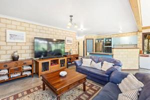 a living room with two couches and a tv at Eagle Bay Beach Lodge - Escape to Coastal Serenity in Dunsborough