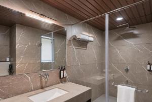 a bathroom with a sink and a shower at Aamba Bagh Resort Kumbhalgarh in Kumbhalgarh