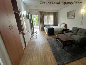 a hotel room with a bed and a couch at Karinga Motel Lismore in Lismore