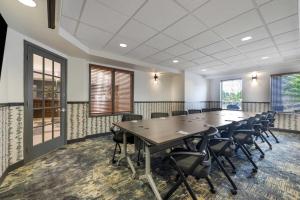 a conference room with a large table and chairs at Days Inn by Wyndham Thunder Bay North in Thunder Bay