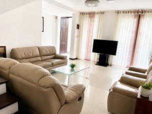 a living room with two couches and a television at Ayubowan Home Stay - Kotikawatta in Angoda