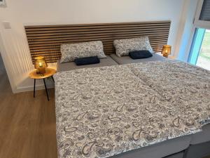 a bedroom with a large bed with a wooden headboard at Idar Apartments 11 in Idar-Oberstein