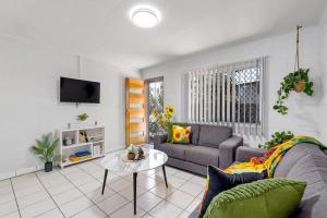 a living room with a couch and a table at Quiet & Comfortable with Wi-fi in Andergrove