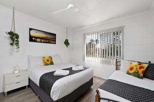 a bedroom with two beds and a window at Quiet & Comfortable with Wi-fi in Andergrove