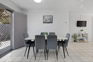 a white dining room with a table and chairs at Quiet & Comfortable with Wi-fi in Andergrove +34 photos
