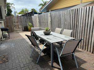 a wooden table and chairs on a patio at Quiet & Comfortable with Wi-fi in Andergrove