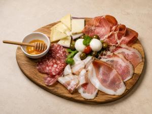 a plate of food with meat and cheese on a table at Masseria Grande Hotel - Ristorante in Montecilfone