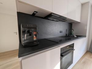 a kitchen with a coffee maker on a counter at Main Ferienwohnung Erlabrunn in Erlabrunn +15 photos
