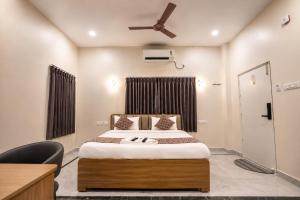 a bedroom with a bed and a ceiling fan at Hotel SSV Suites Premium Near HItech City, Madhapur in Hyderabad +17 photos