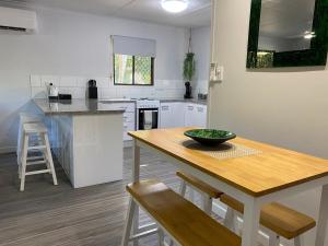 a kitchen with a wooden table with a bowl on it at Ocean Breezes with Leafy View with Wi-fi in Slade Point