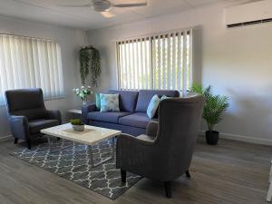 a living room with a couch and a table at Ocean Breezes with Leafy View with Wi-fi in Slade Point