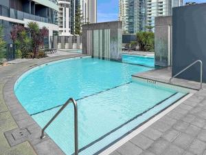 a large blue swimming pool in a city at Oceanview Luxury Escape Oracle Tower 2 Level 24 in Gold Coast