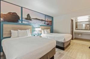 a hotel room with two beds and a fireplace at Days Inn Merced / Yosemite Area in Merced +4 photos