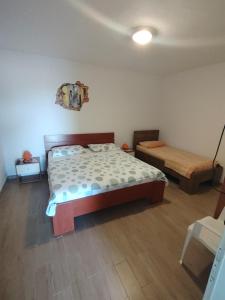a bedroom with a bed and a bench in it at Apartments Berti in Sveta Nedelja