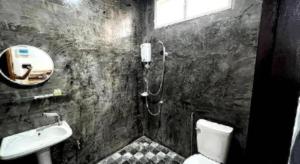a bathroom with a shower and a toilet and a sink at Huen Kham Kaew Resort & KK House cafa Nan in Ban Thung Laeng