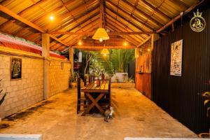 a room with a wooden table and a wooden ceiling at Anoo Garden Villa in Trincomalee